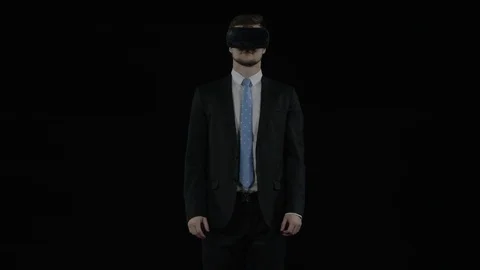 Man on a black background using virtual reality headset Stock Footage 77677723