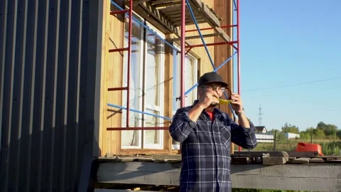 A man in a black baseball cap and yellow glasses 4K Stock Footage 325988045
