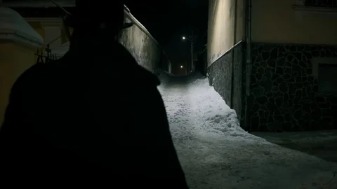 A man in a black cloak walking through the tunnel. Horror scene Vídeos de archivo 102116786