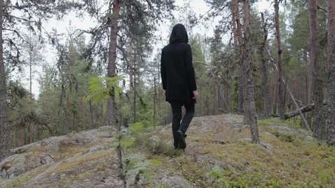 Man in black clothes walking alone in a deep rocky forest. Travel, healthy Stock Footage 121410901