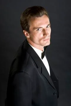 Man in black dinner jacket with bow tie Stock Photos