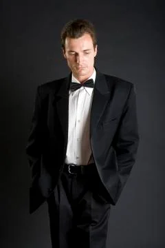 Man in black dinner jacket with bow tie Stock Photos
