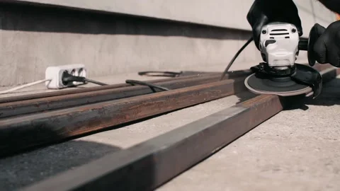 Man in black gloves grinders rusty tube Stock Footage 139896003