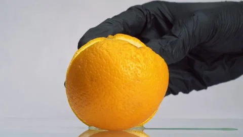 Man in black gloves slice orange fruit with big knife. Orange sliced on two Stock-Footage 150771823
