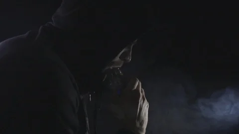 man in black hoodie smoking electronic Stock Video Pond5