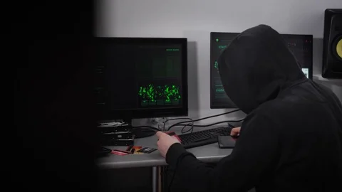 A man in a black jacket and a hood on his head trying to break into someone else 動画素材 72425071