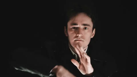 A man in a black jacket in the dark says that the time has come. Deadline Stock Footage 88063751