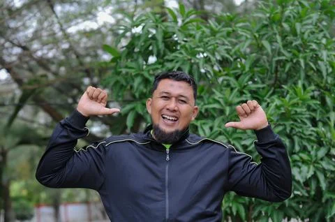 A man with black jacket sign language Stock Photos