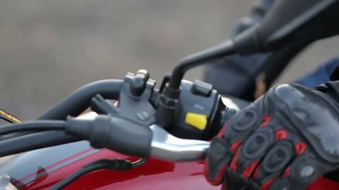 Man in black leather jacket sits on motorcycle turns key Stock Footage 81493533