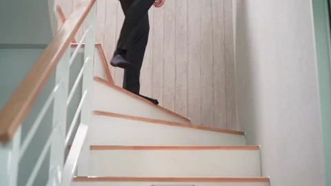 Man in black pants walk down on stairs from 2nd floor to 1st floor Video stock 158383807