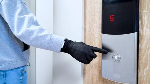 A man in black protective gloves presses the Elevator Stock Footage 128126276