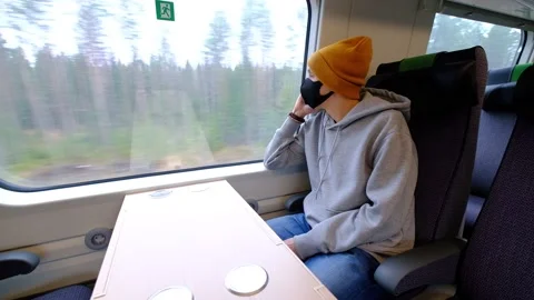 A man in a black protective mask sits alone in the train Video stock 142429408
