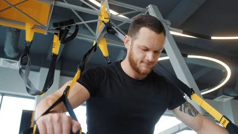 A man in a black shirt doing exercise for hands at the simulator Stock Footage 126980102
