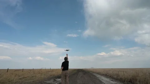 Man in a black shirt having difficultly in catching a landing drone  Stock Footage 154174441