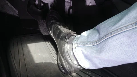 Man in black shoes pressing the  gas and brake pedal while driving. Stock Footage