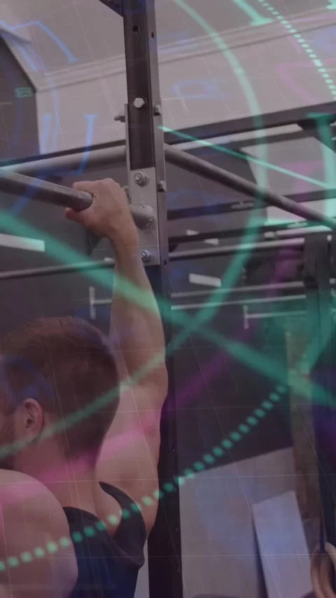 Man in black tank top performing pull-up on horizontal bar at gym, rings, copy Stock Footage 331168248