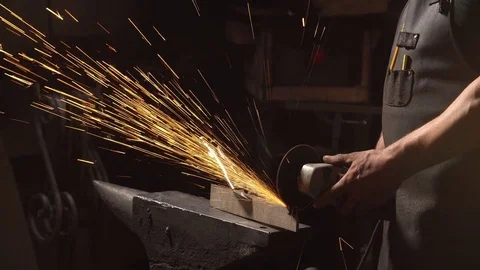 Man of a blacksmith in the working atmosphere. Slow motion Stock Footage 77408961