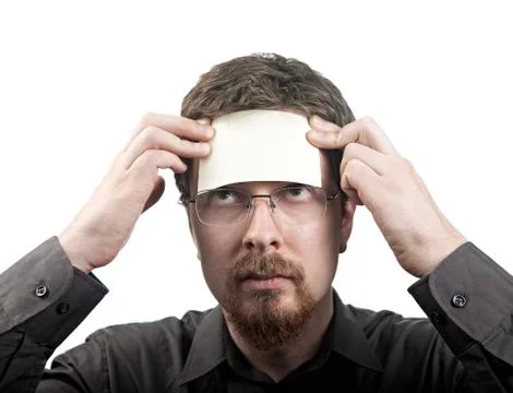 Man with blank note over his forehead Stock Photos