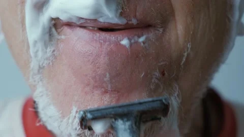 Man bleeding while shaving face with blade scared Stock Footage 169297044