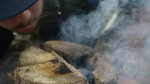 Man blowing a bonfire Stock Footage 68493888