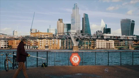Man Blowing Bubbles by River Thames Stock Footage 125089853