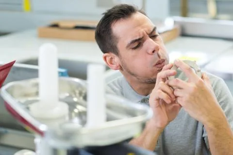 Man blowing dust from component Stock Photos