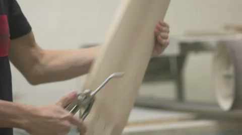 Man blowing dust of the longboard deck Stock Footage 58302703