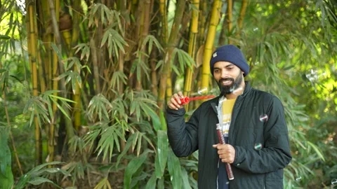 Man blowing soap bubbles in a bamboo forest Stock Footage 341763802