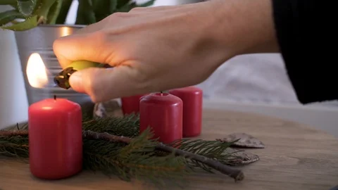 Man blows candles on bedside table with authentic Chrismas decoration. Video stock 102657045