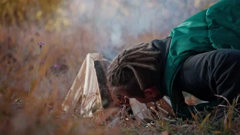 Man blows a fire outside Stock Footage 194271925