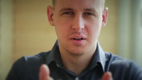 A man blows off his hands with beautiful colored particles Stock Footage 73349097