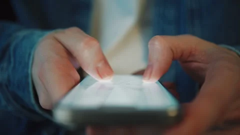 Man in blue denim shirt using smartphone map app in daylight indoors Video stock 329495925