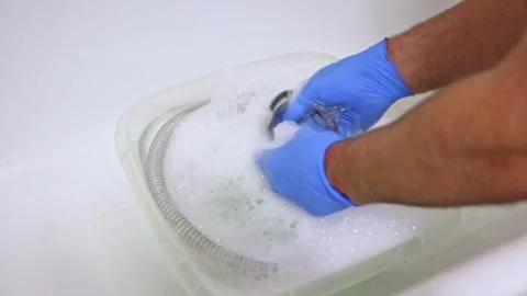 Man with blue gloves cleans cpap hoses and cpap mask as maintenance Stock Footage 254285771