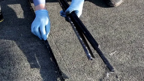 A man in blue gloves is laying out metal parts for painting Stock Footage 89545288