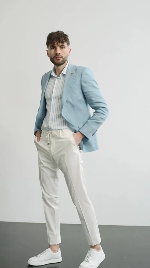 Man in blue jacket and white pants posing for camera Video stock 274162691