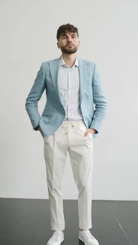 Man in blue jacket and white pants posing for camera 스톡 동영상 277568362