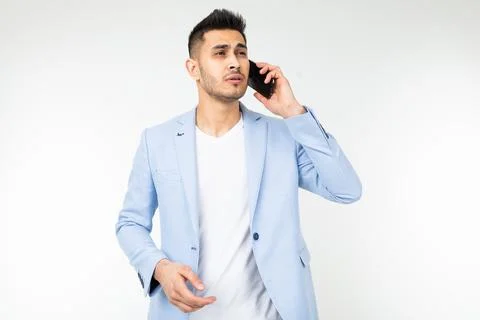Man in a blue jacket is trying to catch mobile communication on a smartphone on Stock Photos