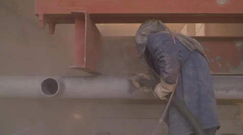 Man in a Blue Robe and Hat Color Steel Grey Paint From the Spray Gun in the Vídeos de archivo 68508026