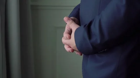 Man in a blue suit jacket waiting nervously. Groom wait his bride. Stock Footage 258937955