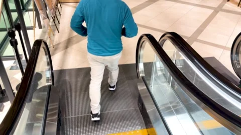 Man in Blue Sweater Descending Escalator in Kanazawa Shopping Center Stock Footage 335797201