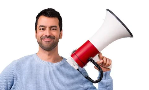 Man with blue sweater shouting through a megaphone Stock Photos