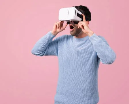 Man with blue sweater using VR glasses. Virtual reality experience Stock Photos