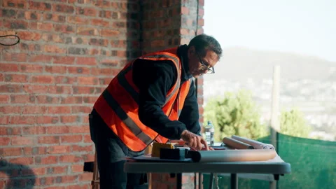 Man, blueprint and architect at construction site for engineering, planning and Stock Footage 336189853