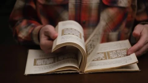 Man in blur is studying chess book. flips through pages. close up. front view. Stock Footage 305216903