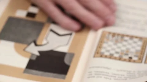 A man in a blur is studying a chess tutorial. visual aid. closeup. Stock Footage 255131561