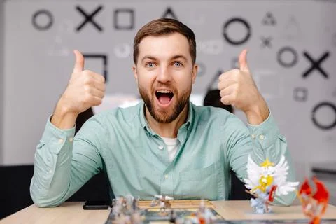 Man with board game piece while practicing strategy in home alone. A man play Stock Photos