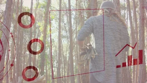 Man with board walking in forest, globe appearing and expanding tech HUD charts Stock Footage 334013766