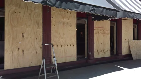 Man Boards Up Storefront Due to Riots and Looting Following George Floyd Death Stock Footage 131785546
