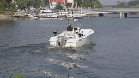 Man in boat in harbour Stock Footage 93285492