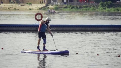 A man in a boat rowing oar Stock Footage 69858491